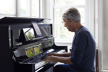 senior man at the piano