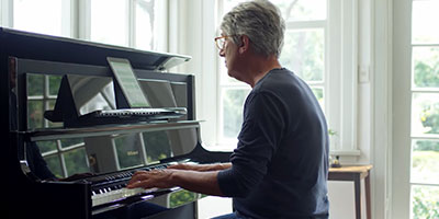 older man playing the piano