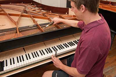 man tuning bosendorfer piano